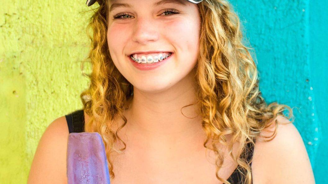 Teenager smiling with braces on her teeth