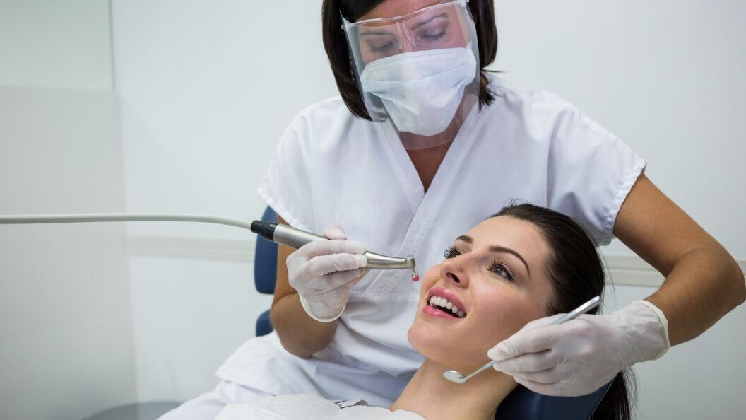 Dentist performing a routine dental checkup and cleaning